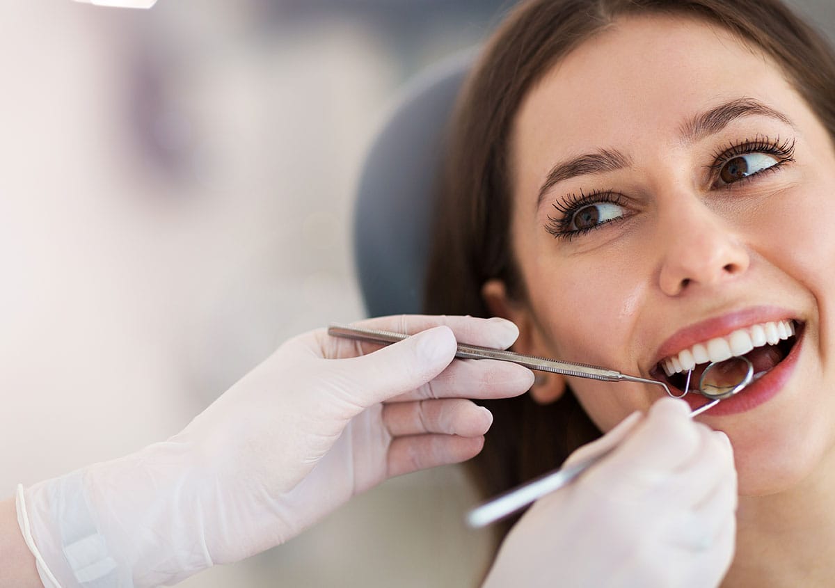 A woman is smiling at dental