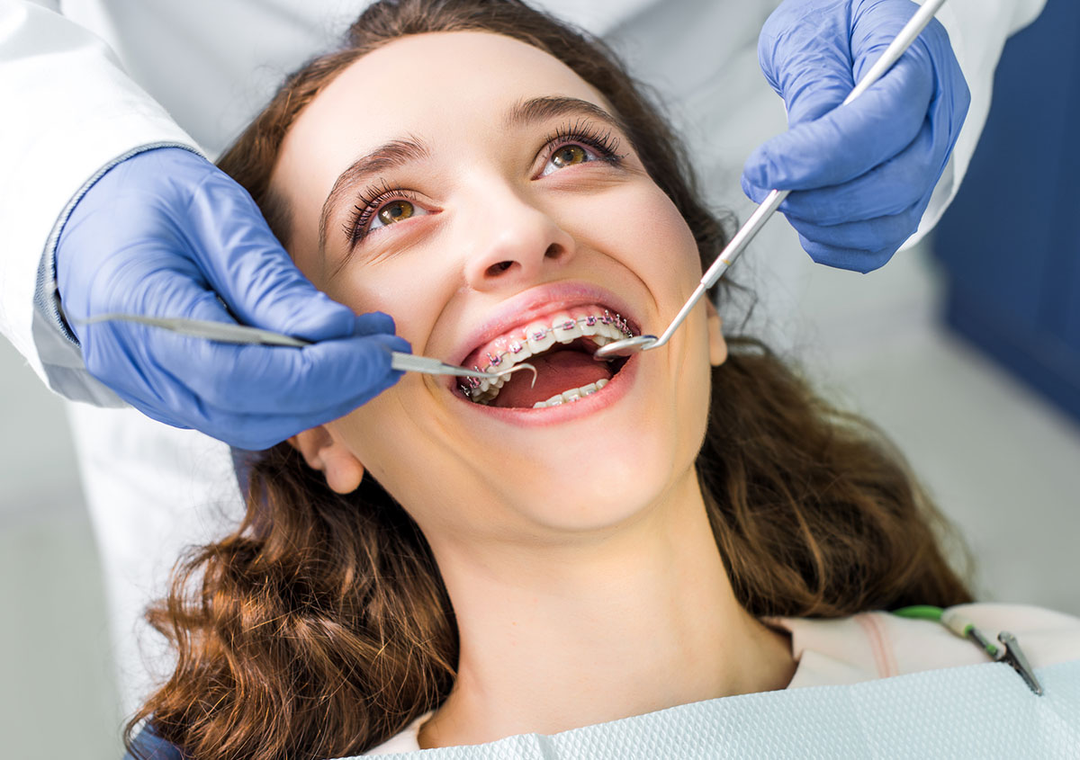 A woman is smiling at dental
