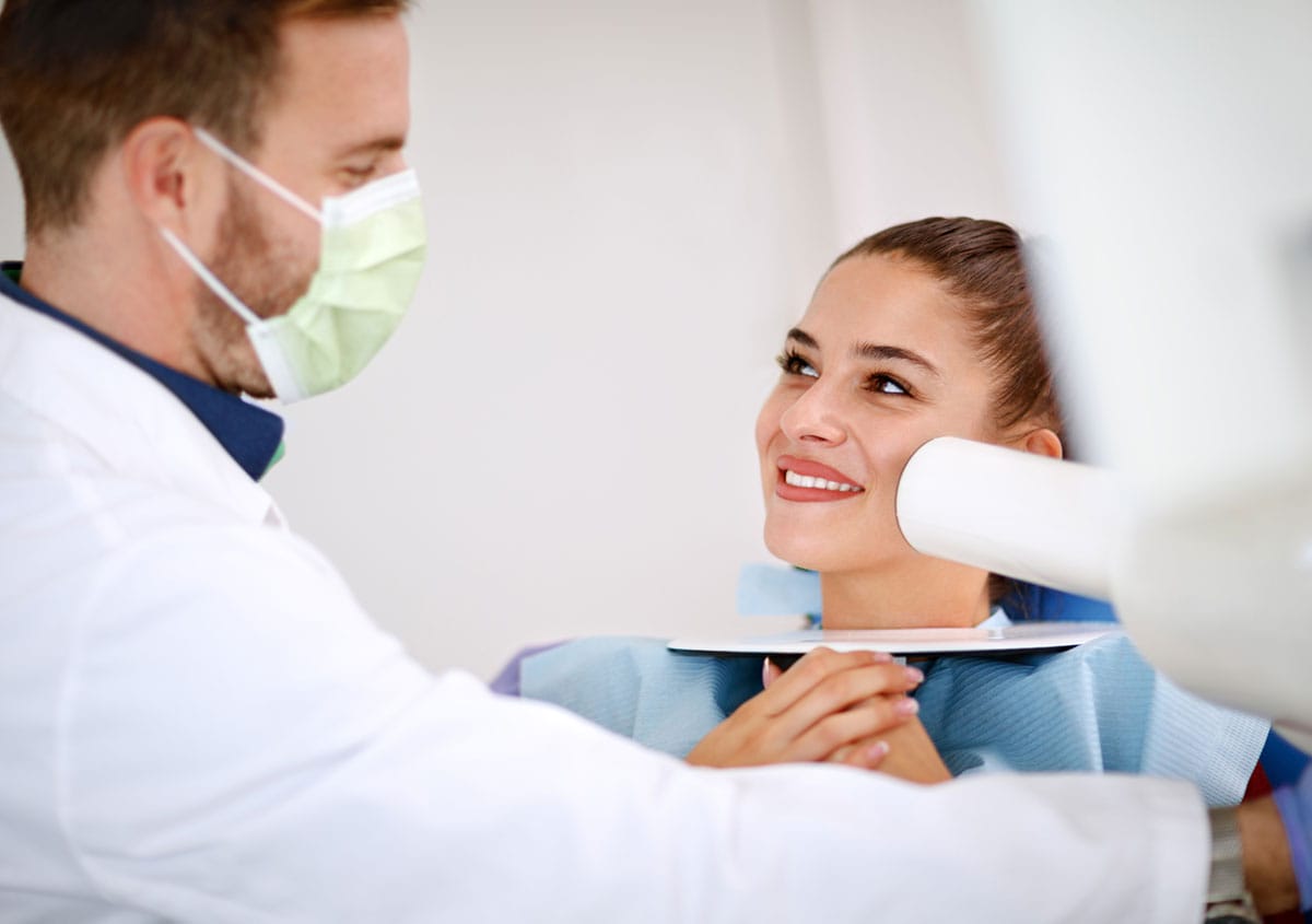 A woman is smiling at dental