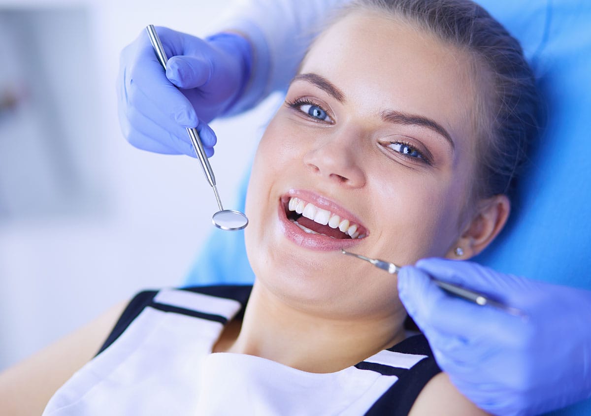 A woman is smiling at dental