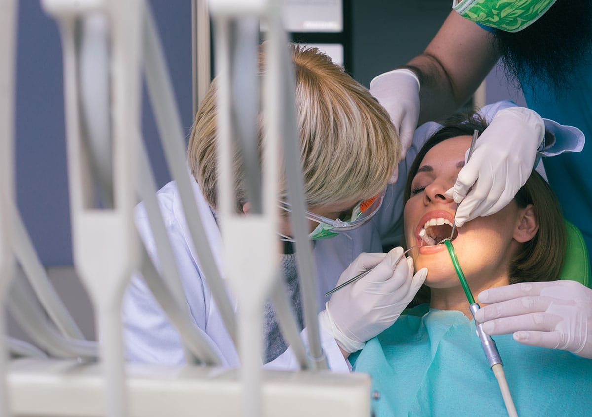 A woman is having dental surgery