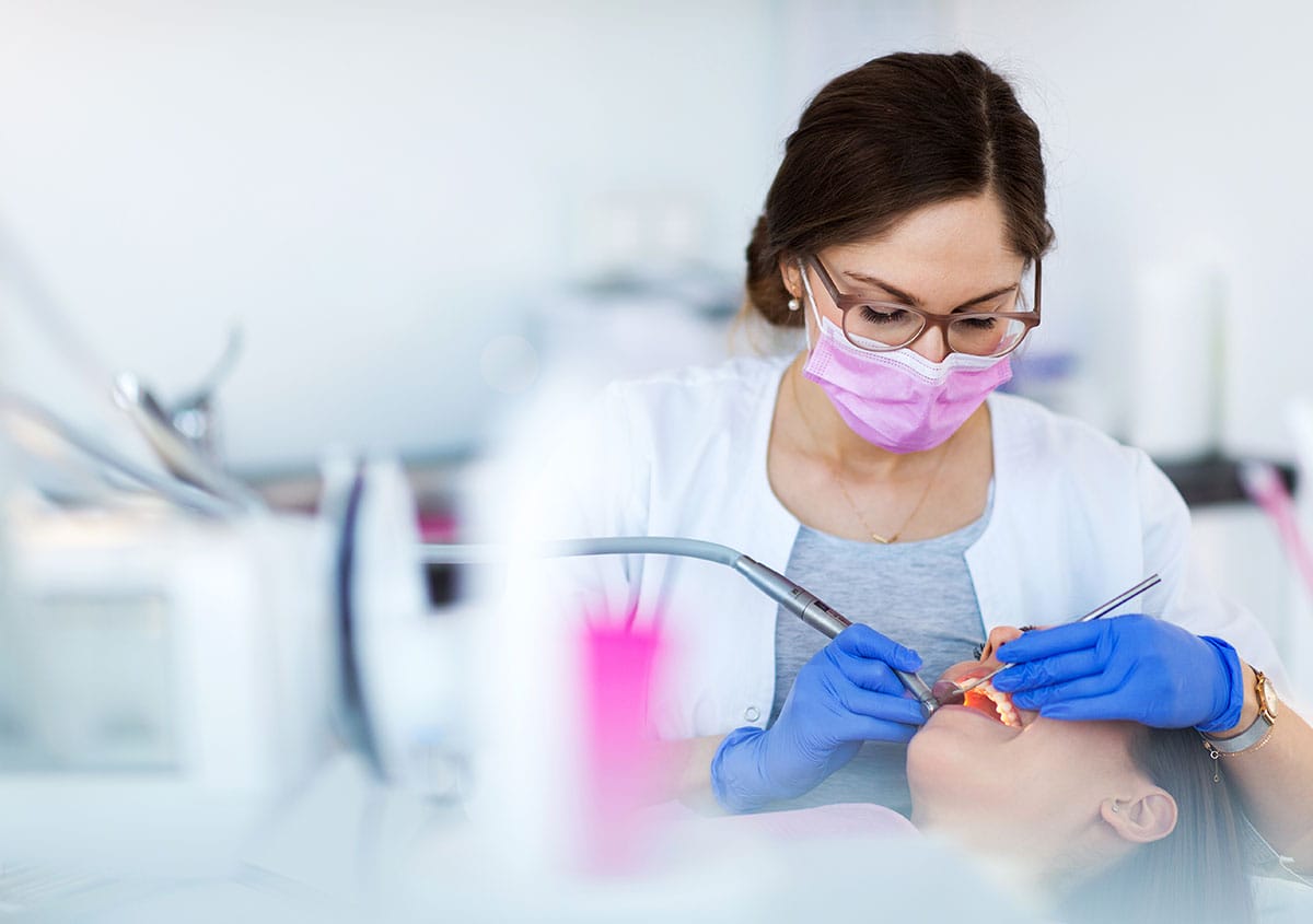 A woman is having dental surgery