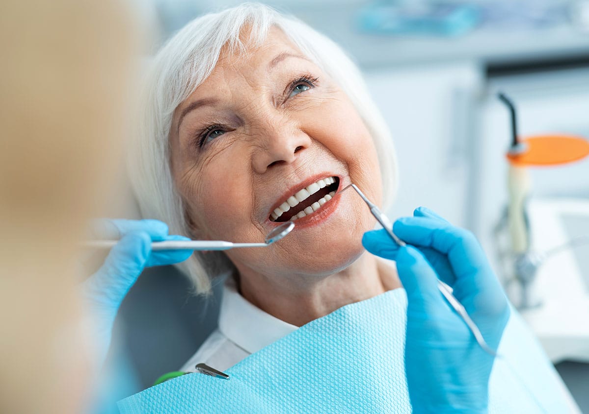 A senior woman is having dental check-up at dental