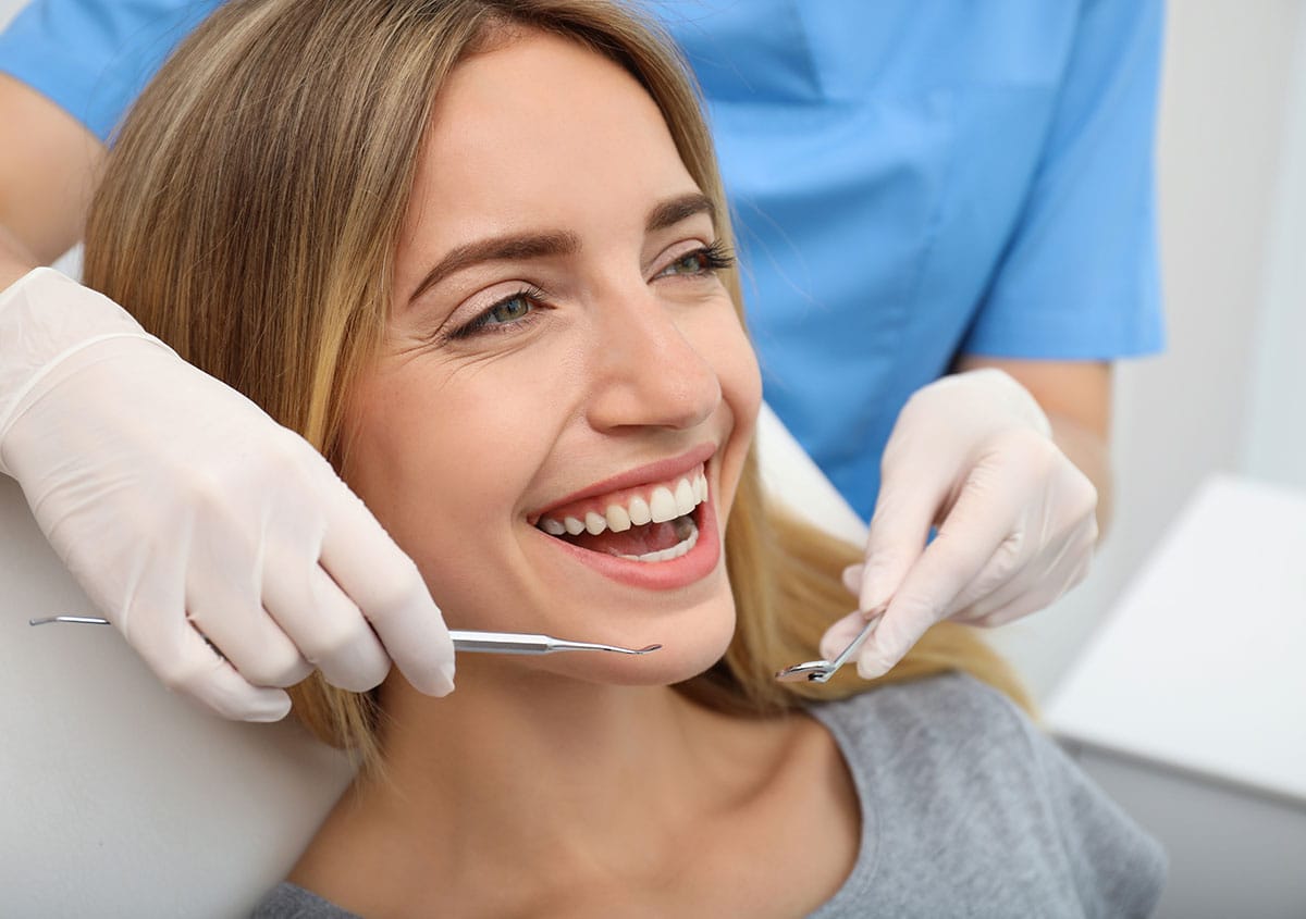 A woman is smiling at dental