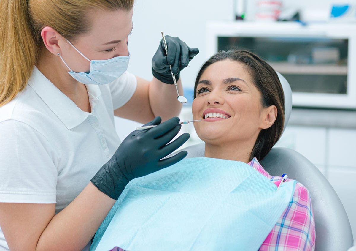 A beautiful woman is smiling at dental