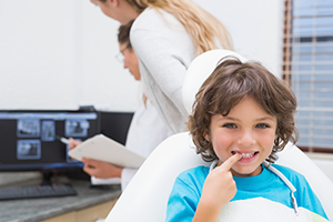 Little boy pointing at his teeth